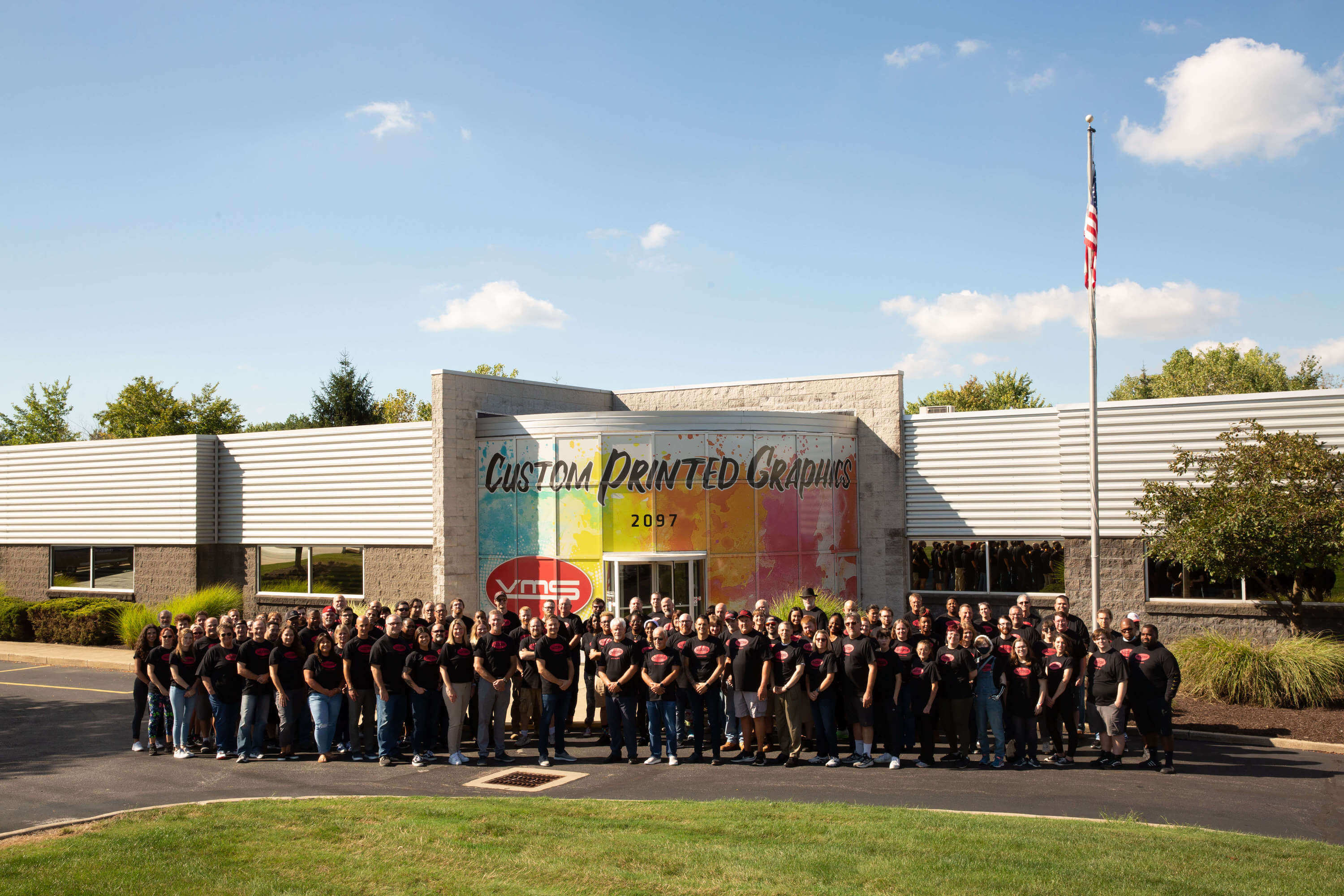 Visual Marking Systems employees in front of building