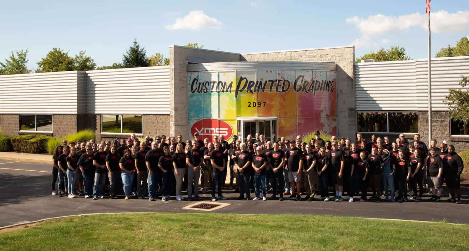 team in front of VMS building