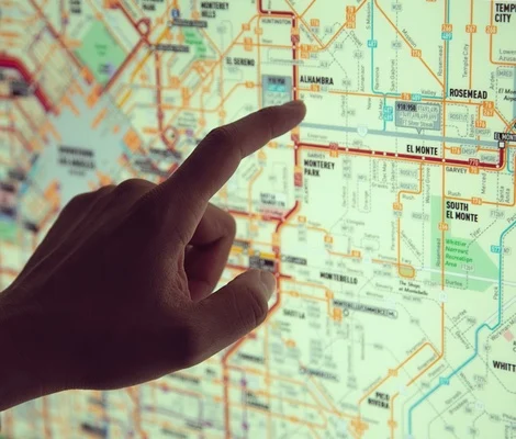 hand pointing at destination on wayfinding sign